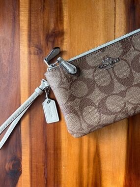 COACH Signature Canvas Corner Zip Wristlet in Brown/Tan with Sage Strap